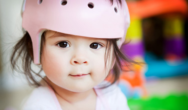 a kid with a pink helmet