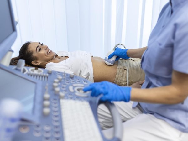 ultrasound-diagnostic-stomach-abdominal-woman-clinic-closeup-view-doctor-runs-ultrasound-sensor-patient-s-girl-tummy-looks-image-screen-diagnosis-internal-organs